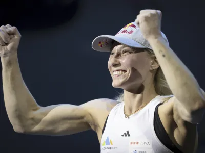 Winner Janja Garnbret of Slovenia celebrates the victory after winning the women's Boulder&Lead final at the IFSC Climbing World Championship 2023, at the PostFinance Arena, in Bern, Switzerland, Friday, Aug. 11, 2023. (Anthony Anex/Keystone via AP)