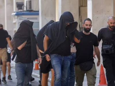 Soccer fans detained following violent clashes between AEK Athens and Dinamo Zagreb soccer fans, that lead to the death of a man, are taken to a magistrate, in Athens, Greece, August 11, 2023. REUTERS/Louiza Vradi