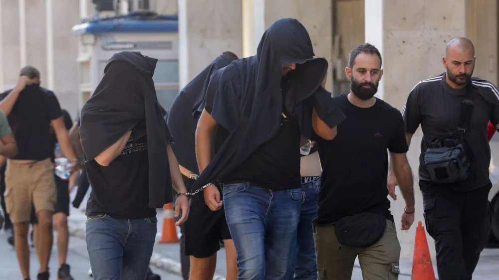 Soccer fans detained following violent clashes between AEK Athens and Dinamo Zagreb soccer fans, that lead to the death of a man, are taken to a magistrate, in Athens, Greece, August 11, 2023. REUTERS/Louiza Vradi