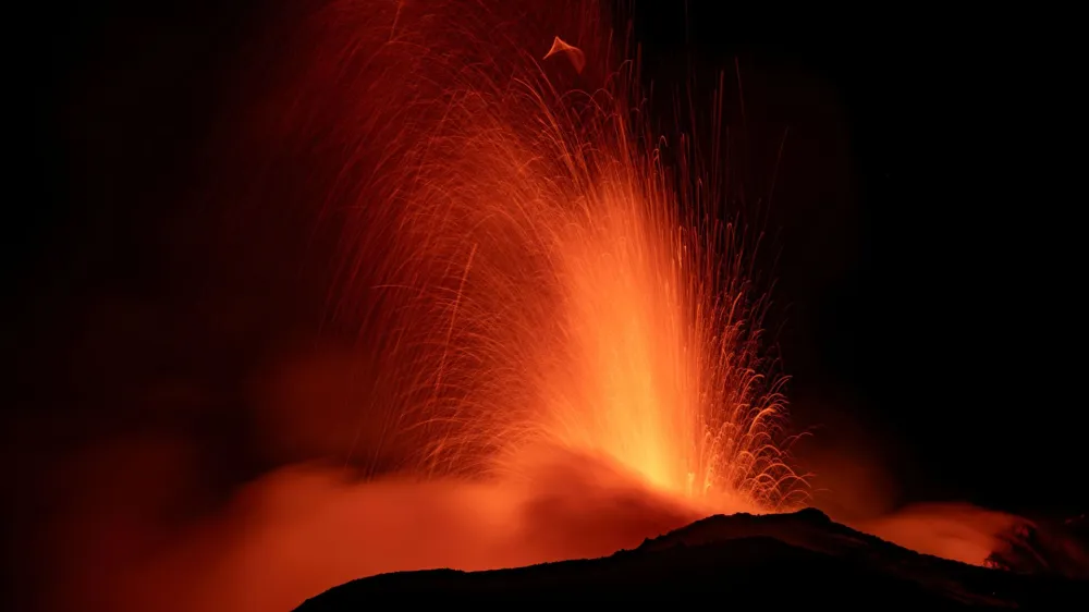 Mount Etna, Europe's most active volcano, lights up the night sky with eruptions as seen from Rocca Della Valle, Italy, August 13, 2023. Etna Walk/Marco Restivo/ Handout via REUTERS ATTENTION EDITORS - THIS IMAGE HAS BEEN SUPPLIED BY A THIRD PARTY.   TPX IMAGES OF THE DAY