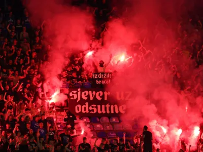 Soccer Football - Champions League - Qualifying Third Round - First Leg - Dinamo Zagreb v AEK Athens - Maksimir stadium, Zagreb, Croatia - August 15, 2023 Dinamo Zagreb fans with flares and a banner reading "hold on brothers" in the stands REUTERS/Antonio Bronic