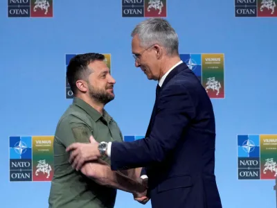 FILE PHOTO: Ukraine's President Volodymyr Zelenskiy and NATO Secretary-General Jens Stoltenberg shake hands at a press conference during a NATO leaders summit in Vilnius, Lithuania, July 12, 2023. REUTERS/Ints Kalnins/File Photo