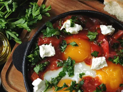 ﻿Fried eggs with vegetables and feta cheese. Shakshuka. Keto diet. Keto breakfast or snack. Middle Eastern style.