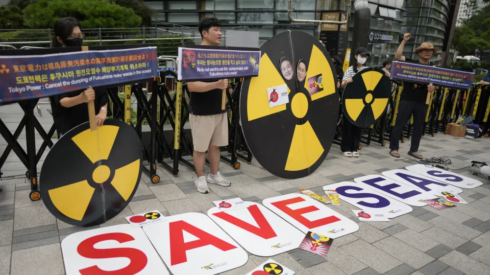 Members of environmental civic groups shout slogans during a rally to denounce the Japanese government's decision to release treated radioactive water into the sea from the damaged Fukushima nuclear power plant, outside of a building which houses Japanese Embassy, in Seoul, South Korea, Tuesday, Aug. 22, 2023. Japan will start releasing treated and diluted radioactive wastewater from the Fukushima Daiichi nuclear plant into the Pacific Ocean as early as Thursday, a controversial but essential early step in the decades of work to shut down the facility 12 years after its meltdown disaster. (AP Photo/Lee Jin-man)