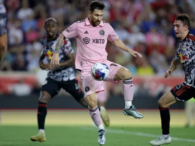 Aug 26, 2023; Harrison, New Jersey, USA; Inter Miami CF forward Lionel Messi (10) controls the ball against New York Red Bulls defender Andres Reyes (4) and midfielder Peter Stroud (5) during the second half at Red Bull Arena. Mandatory Credit: Brad Penner-USA TODAY Sports