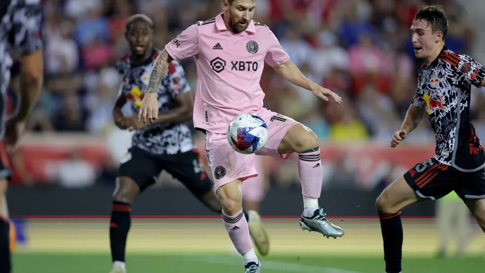 Aug 26, 2023; Harrison, New Jersey, USA; Inter Miami CF forward Lionel Messi (10) controls the ball against New York Red Bulls defender Andres Reyes (4) and midfielder Peter Stroud (5) during the second half at Red Bull Arena. Mandatory Credit: Brad Penner-USA TODAY Sports