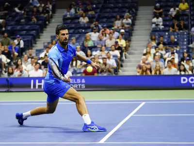 Novak Djokovic, of Serbia, returns a shot to Alexandre Muller, of France, during the first round of the U.S. Open tennis championships, Tuesday, Aug. 29, 2023, in New York. (AP Photo/Frank Franklin II)