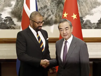 British Foreign Secretary James Cleverly, left, and Chinese Foreign Minister Wang Yi shake hands before a meeting at the Diaoyutai State Guesthouse in Beijing, Wednesday, Aug. 30, 2023. (Florence Lo/Pool Photo via AP)