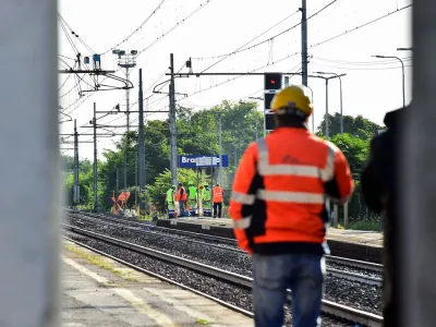 Officials walk on rail tracks on the site of a train accident in which workers were killed, in Brandizzo, Italy, August 31, 2023. REUTERS/Massimo Pinca