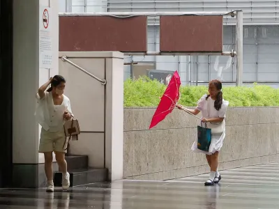 People walk on a street as Typhoon Haikui approaches, in Taipei, Taiwan September 3, 2023. REUTERS/Ann Wang