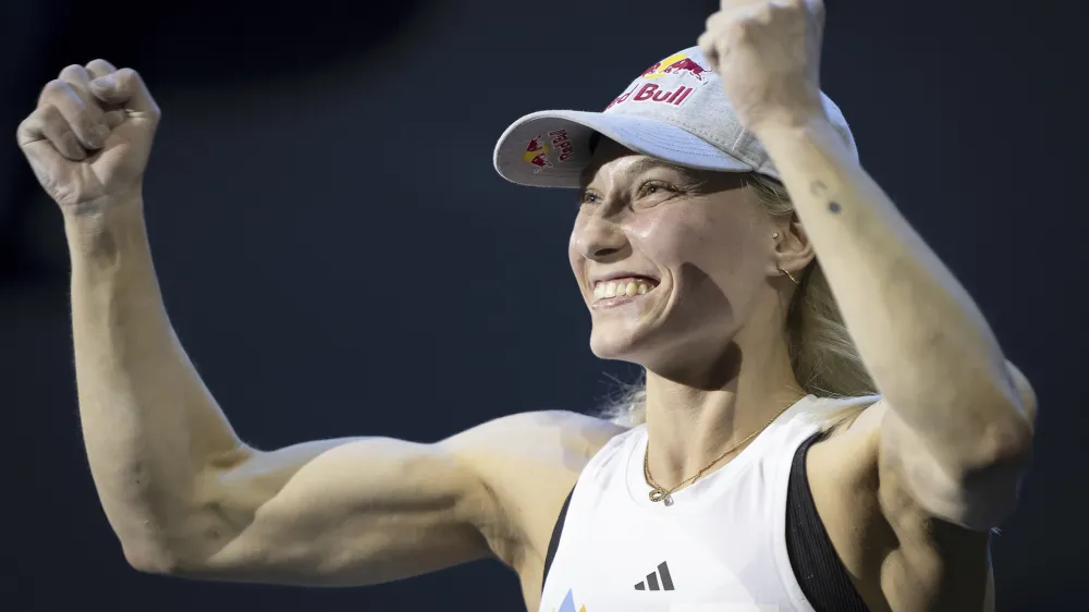 Winner Janja Garnbret of Slovenia celebrates the victory after winning the women's Boulder&Lead final at the IFSC Climbing World Championship 2023, at the PostFinance Arena, in Bern, Switzerland, Friday, Aug. 11, 2023. (Anthony Anex/Keystone via AP)