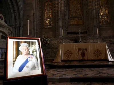 A portrait of Britain's Queen Elizabeth is displayed inside St Davids Cathedral, ahead of the arrival of Britain's Prince William, and Kate, Princess of Wales, on the first anniversary of Queen Elizabeth's death, in St. Davids, Wales, Britain, Friday, Sept. 8, 2023. (Toby Melville/Pool Photo via AP)