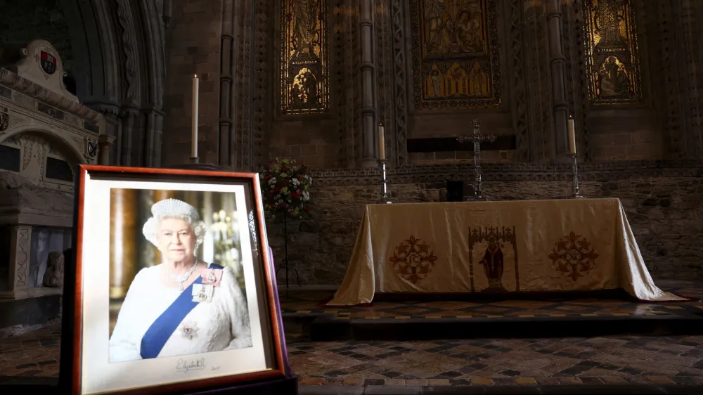 A portrait of Britain's Queen Elizabeth is displayed inside St Davids Cathedral, ahead of the arrival of Britain's Prince William, and Kate, Princess of Wales, on the first anniversary of Queen Elizabeth's death, in St. Davids, Wales, Britain, Friday, Sept. 8, 2023. (Toby Melville/Pool Photo via AP)