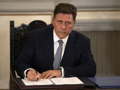 FILE - In this Tuesday, June 27, 2023, file photo, Greece's shipping minister, Miltiadis Varvitsiotis signs a protocol after Greece's new government swearing in ceremony at the Presidential palace, in Athens, Greece. Varvitsiotis, has resigned on Monday, Sept. 11, 2023 over the death last week of a ferry passenger who was pushed off an entry ramp by a crew member after arriving late. (AP Photo/Thanassis Stavrakis, File)