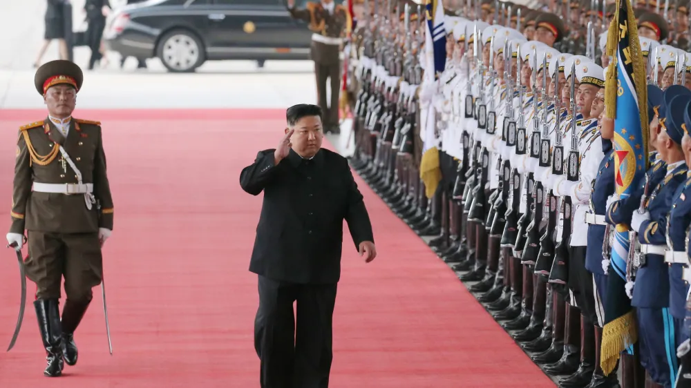 HANDOUT - 11 September 2023, North Korea, Pyongyang: A picture released by the North Korean state news agency (KCNA) on 12 September 2023 shows North Korea leader Kim Jong-un waving as he inspects an honor guard before boarding a train in Pyongyang to visit Russia to hold talks with Russian President Vladimir Putin. Photo: -/kcna/dpa - ATTENTION: editorial use only and only if the credit mentioned above is referenced in full