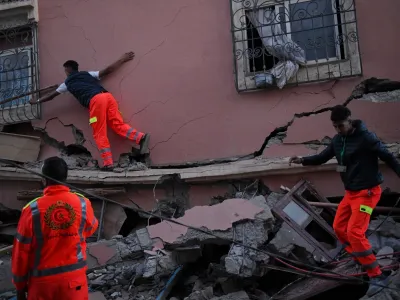 11 September 2023, Morocco, Al Haouz: Workers walk through the rubble of a collapsed building in the town of Talat N'Yaaqoub, south of Marrakesh, after the powerful earthquake that hit Morocco late Friday. Photo: Fernando Sánchez/EUROPA PRESS/dpa