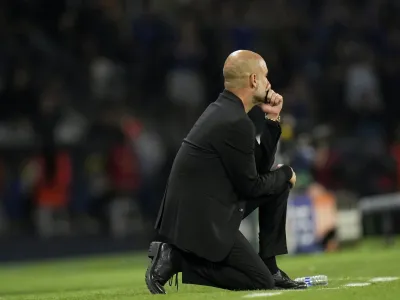 Manchester City's head coach Pep Guardiola kneels by the touchline during the Champions League final soccer match between Manchester City and Inter Milan at the Ataturk Olympic Stadium in Istanbul, Turkey, Saturday, June 10, 2023. (AP Photo/Francisco Seco)