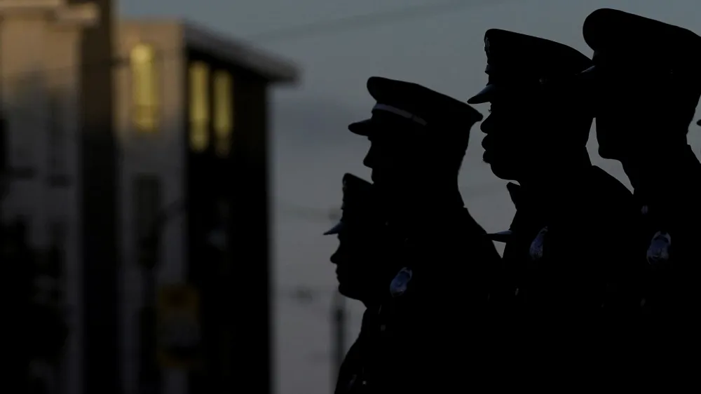 San Francisco Firefighters listen as the names of the firefighters and emergency responders who lost their lives on Sept. 11, 2001, are read at a fire station in San Francisco, Monday, Sept. 11, 2023. Americans are looking back on the horror and legacy of 9/11, gathering Monday, Sept. 11, 2023, at memorials, firehouses, city halls and elsewhere to observe the 22nd anniversary of the deadliest terror attack on U.S. soil. (AP Photo/Jeff Chiu)