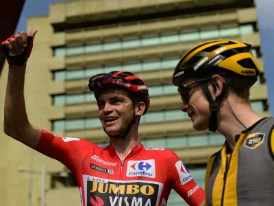 Jumbo Visma's Sepp Kuss, left, next to Jonas Vingegaard, waves fans before the start of the thirteen stage of La Vuelta between Pamplona and Lekunberri, 158,5 km (98.4 miles) in Pamplona, northern Spain, Sunday Sept. 10, 2023. (AP Photo/Alvaro Barrientos)