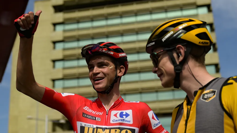 Jumbo Visma's Sepp Kuss, left, next to Jonas Vingegaard, waves fans before the start of the thirteen stage of La Vuelta between Pamplona and Lekunberri, 158,5 km (98.4 miles) in Pamplona, northern Spain, Sunday Sept. 10, 2023. (AP Photo/Alvaro Barrientos)