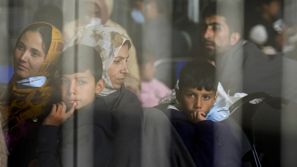 FILE - Evacuees from Afghanistan wait with other evacuees to fly to the United States or another safe location in a makeshift departure gate inside a hanger at the United States Air Base in Ramstein, Germany, Sept. 1, 2021. The Afghan man who speaks only Farsi represented himself in U.S. immigration court, and the judge denied him asylum. The Associated Press obtained a transcript of the hearing that offers a rare look inside an opaque and overwhelmed immigration court system where hearings are closed and judges are under pressure to move quickly given the backlog of 2 million cases. (AP Photo/Markus Schreiber, File)