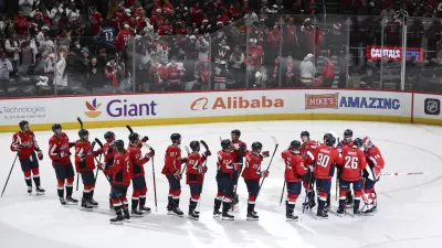 Washington Capitals players greet each other after defeating the Los Angeles Kings in an NHL hockey game, Sunday, Dec. 22, 2024, in Washington. (AP Photo/Terrance Williams)