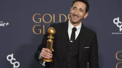 Adrien Brody poses in the press room with the award for best performance by a male actor in a motion picture - drama for "The Brutalist" during the 82nd Golden Globes on Sunday, Jan. 5, 2025, at the Beverly Hilton in Beverly Hills, Calif. (AP Photo/Chris Pizzello)