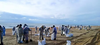 In this photo released by Krasnodar Gov. Veniamin Kondratyev in his Telegram channel on Sunday, Jan. 5, 2025, rescuers and volunteers work to clean up tons of fuel oil that spilled out of two storm-stricken tankers more than two weeks ago in the Kerch Strait, near Anapa in Russia's southern Krasnodar region. (Krasnodar Gov. Veniamin Kondratyev Telegram channel via AP)