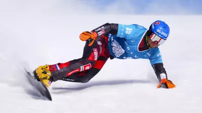 Slovakian Zan Kosir races in qualification round of the men's parallel slalom FIS Snowboard Alpine World Cup at Val Saint-Come in Saint-Come, Quebec, Canada, on Saturday, Feb. 15, 2025. (Sean Kilpatrick/The Canadian Press via AP)