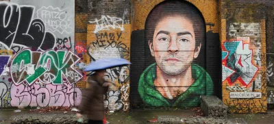 A pedestrian walks past a mural of Luigi Mangione, the suspect in the killing of UnitedHealth Group chief executive Brian Thompson, in East London, Britain February 26, 2025. REUTERS/Temilade Adelaja