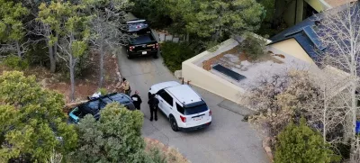 Law enforcement officials talk outside the home of actor Gene Hackman on Thursday, Feb. 27, 2025 in Santa Fe, New Mexico. Hackman, his wife Betsy Arakawa and their dog were found dead in the home a day earlier. (AP Photo/Roberto Rosales)