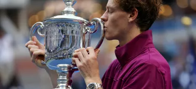 FILE PHOTO: Tennis - U.S. Open - Flushing Meadows, New York, United States - September 8, 2024 Italy's Jannik Sinner celebrates with the trophy after winning his final match against Taylor Fritz of the U.S. REUTERS/Mike Segar/File Photo