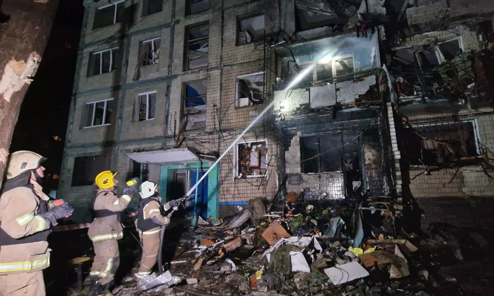 03 October 2024, Ukraine, Kharkiv: Firefighters extinguish the fire in a residential building that was damaged by a Russian missile attack. Photo: ---/Ukrinform/dpa