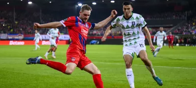 Heidenheim's Patrick Mainka, left, in action against Ljubljana's Marko Ristic during the Conference League soccer match between 1. FC Heidenheim and Olimpija Ljubljana in Heidenheim, Germany, Thursday, Oct. 3, 2024. (Tom Weller/dpa via AP)