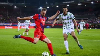 Heidenheim's Patrick Mainka, left, in action against Ljubljana's Marko Ristic during the Conference League soccer match between 1. FC Heidenheim and Olimpija Ljubljana in Heidenheim, Germany, Thursday, Oct. 3, 2024. (Tom Weller/dpa via AP)