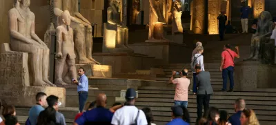 Tourists look at Pharaonic statues displayed at the Grand Staircase of the Grand Egyptian Museum during a partial trial in Giza, Egypt, October 15, 2024. REUTERS/Mohamed Abd El Ghany