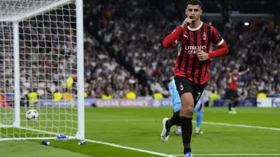 AC Milan's Alvaro Morata celebrates after scoring his side's 2nd goal against Real Madrid during the Champions League opening phase soccer match at the Santiago Bernabeu stadium in Madrid, Spain, Tuesday, Nov. 5, 2024. (AP Photo/Manu Fernandez)