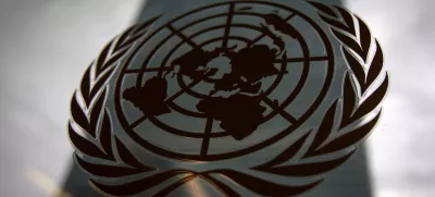 FILE PHOTO: The United Nations headquarters building is pictured though a window with the UN logo in the foreground in the Manhattan borough of New York August 15, 2014. REUTERS/Carlo Allegri/File Photo